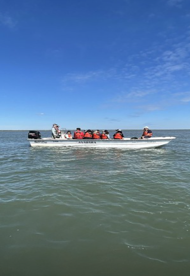 Student on a motor boat on unknown body of water