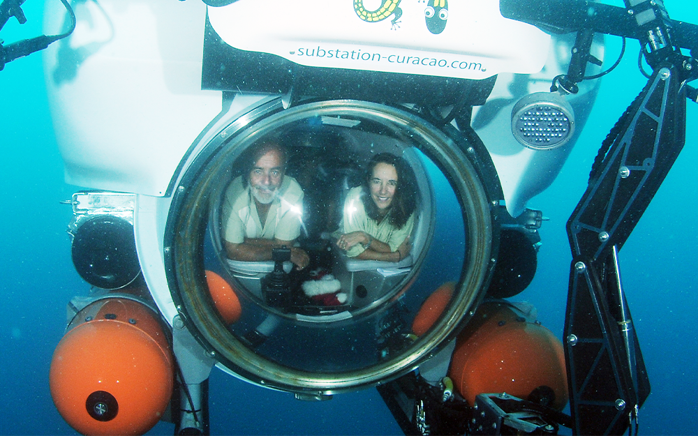 Carole Baldwin Ph.D. ’92 in a research submersible with Substation Curaçao owner Adriaan 'Dutch' Schrie. Photo by Barry Brown, Substation Curaçao; provided by Carole Baldwin.