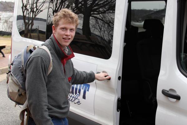A W&amp;M undergrad opens door to Batten School &amp; VIMS shuttle.