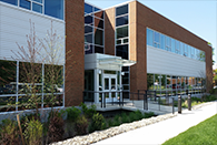 Modern brick and glass building with an entrance walkway and landscaping, identified as Davis Hall at VIMS.
