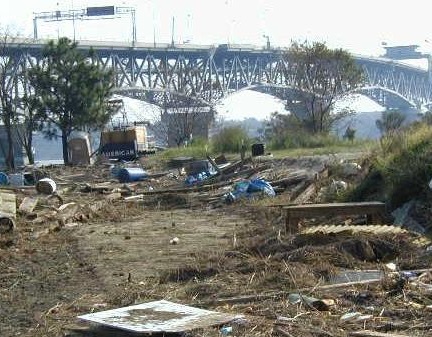 Trash on land near wetlands following a large storm.
