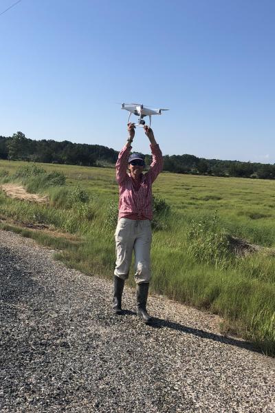 Grace Molino catches drone while out on field work.