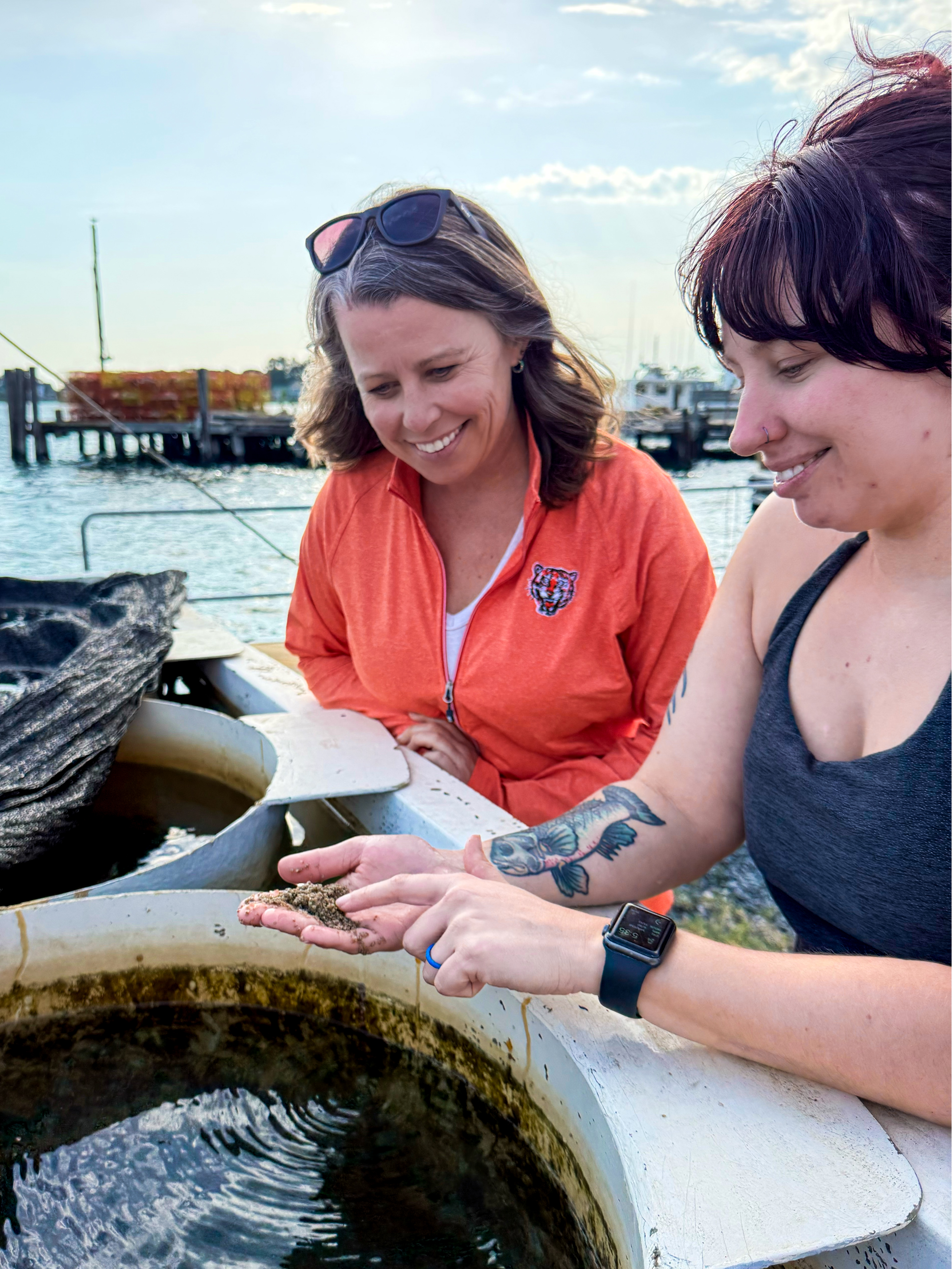 Adriane Michaelis and Sam Glover discuss resiliency strategies for oyster seed production at Oyster Seed Holdings. Photo by Somers Smott.