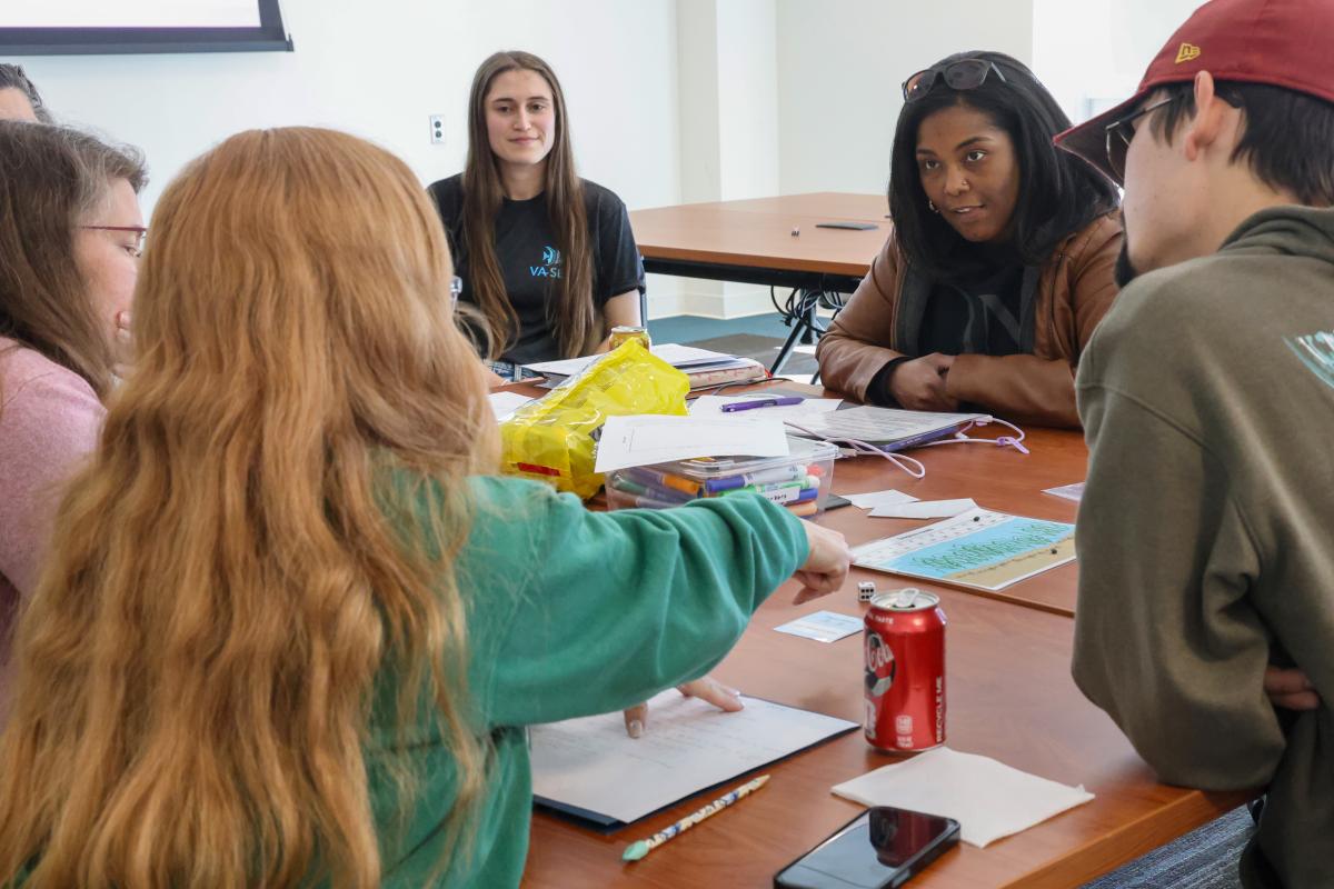 Virginia educators discuss a draft lesson plan designed by Batten &amp; VIMS graduate student and VA SEA participant, Robyn Dudrick (center). Photo by John Wallace.