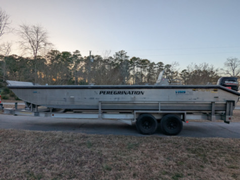 Photo of R/V Peregrination, a 30-foot, aluminum-bodied Carolina skiff, sitting on a trailer.