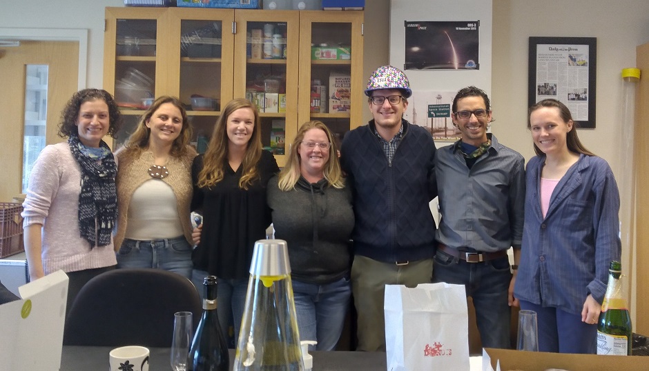 7 members of Coastal Geology lab group pose to celebrate Justin Shawler's PhD defense